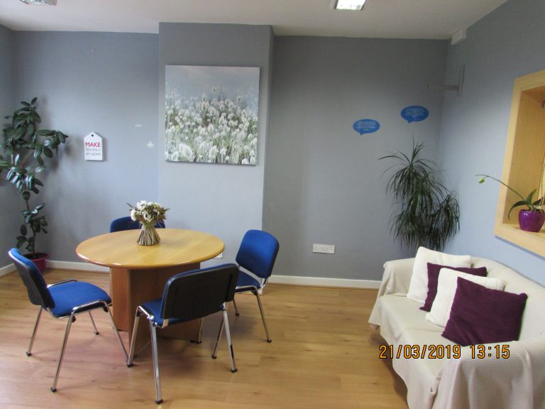 Room at The Finglas Centre with chairs around a table and a sofa
